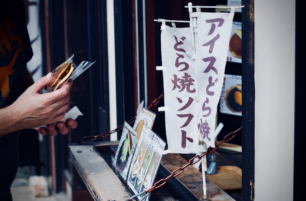 photo of person holding food