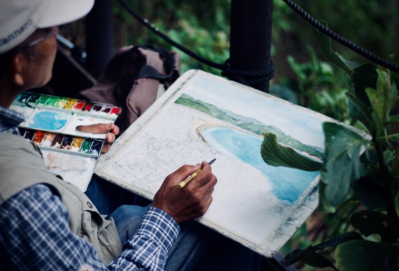 Senior woman painting with watercolors at a table