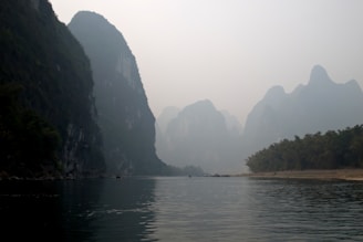 A tranquil view of the Li River surrounded by karst mountains.