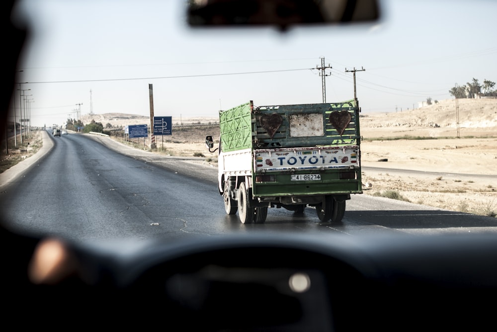 green and white Toyota truck under clear sky during daytime