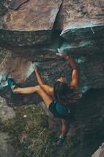 photo of woman climbing mountain