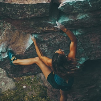 photo of woman climbing mountain