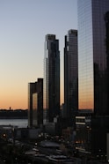 five curtain-wall buildings overlapping other buildings during golden hour photo