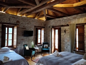 two brown wooden armchairs inside of room during daytime