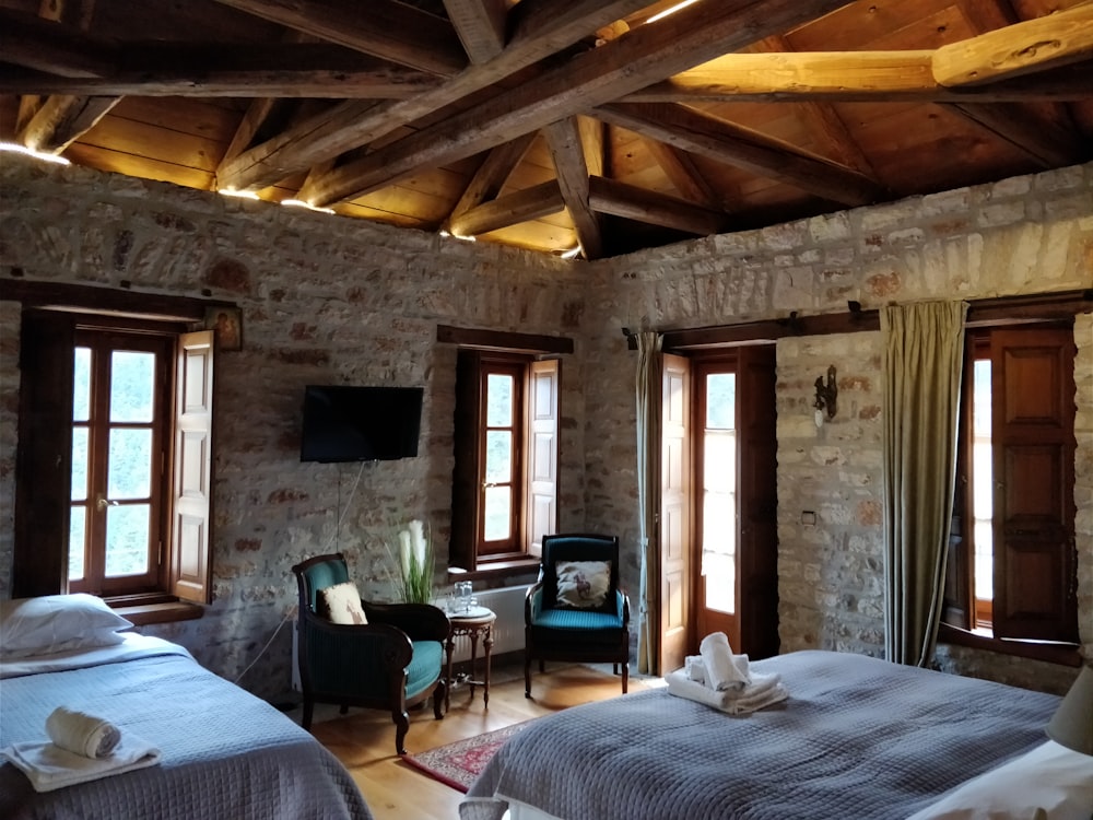 two brown wooden armchairs inside of room during daytime