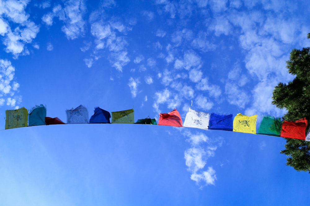 assorted-color textiles hanging on string during daytime