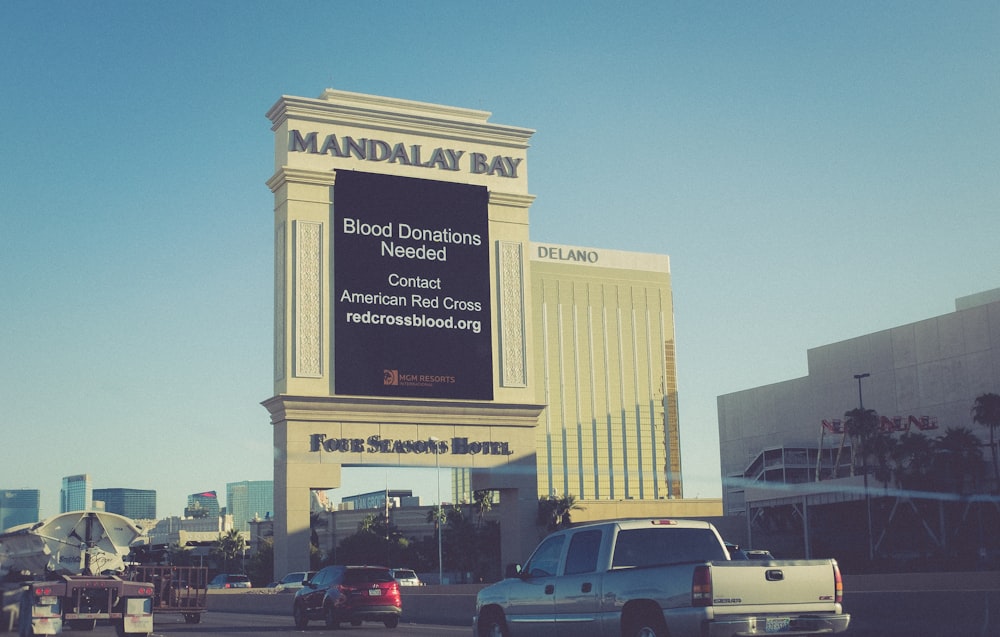 cars passing by Mandalay Bay during daytime