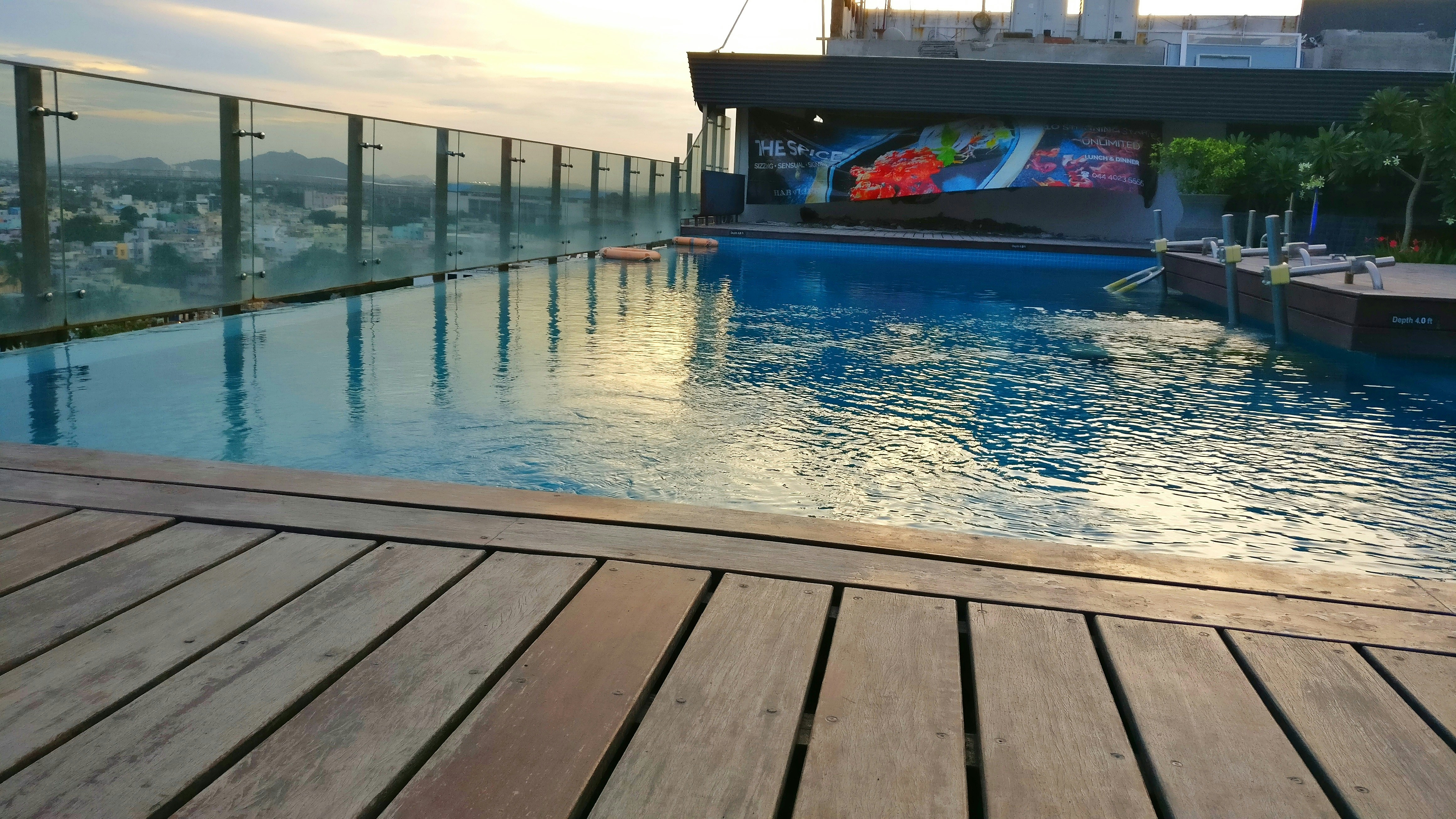Hotel pool deck at sunset with city views