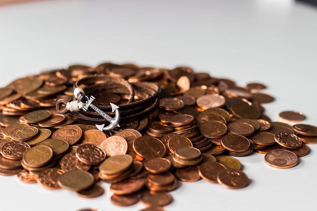 pile of pennies with anchor pin 
