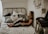 woman leaning on wall while sitting on bed