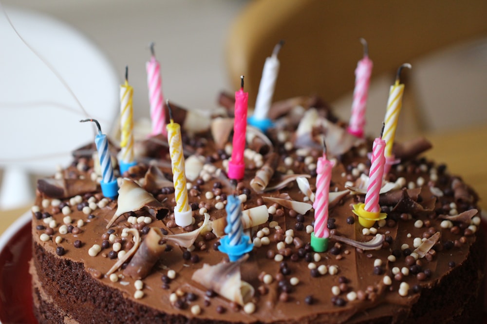 round chocolate cake with candles on top