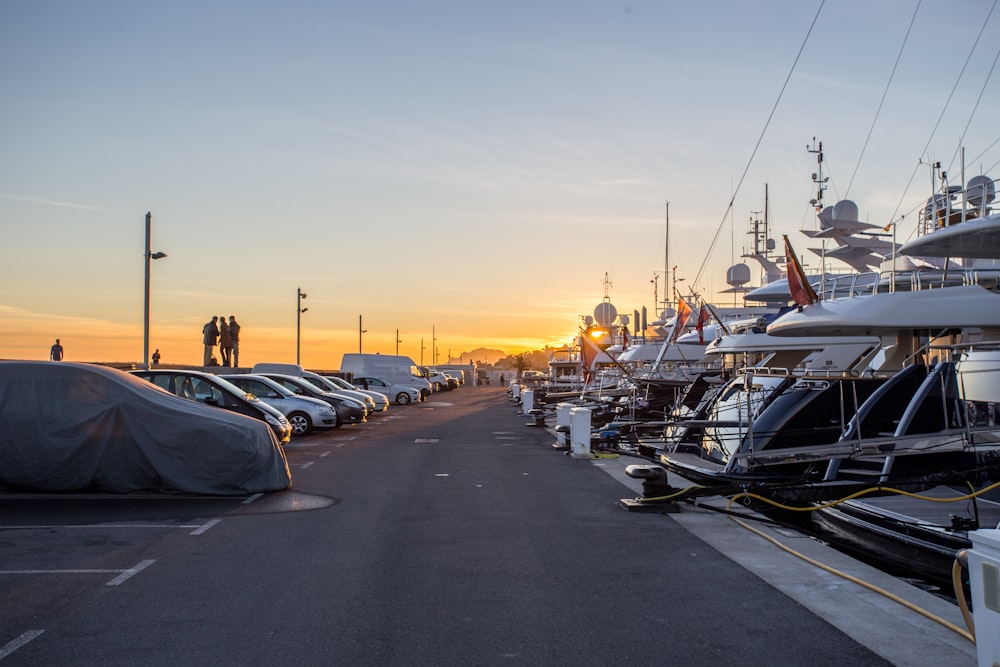 cars in front of yacht during sunset