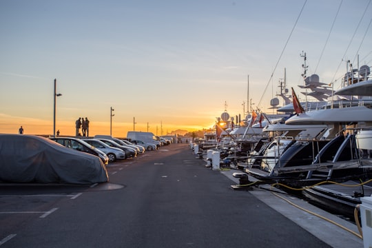 cars in front of yacht during sunset in Golfe-Juan France