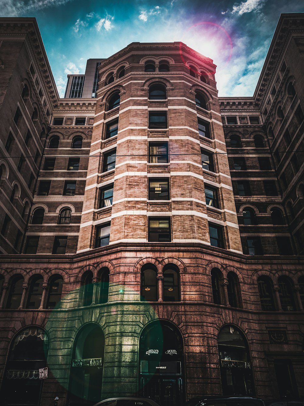 vignette photography of brown brick high-rise building