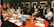 A diverse group of professionals engaged in a collaborative meeting around a conference table.