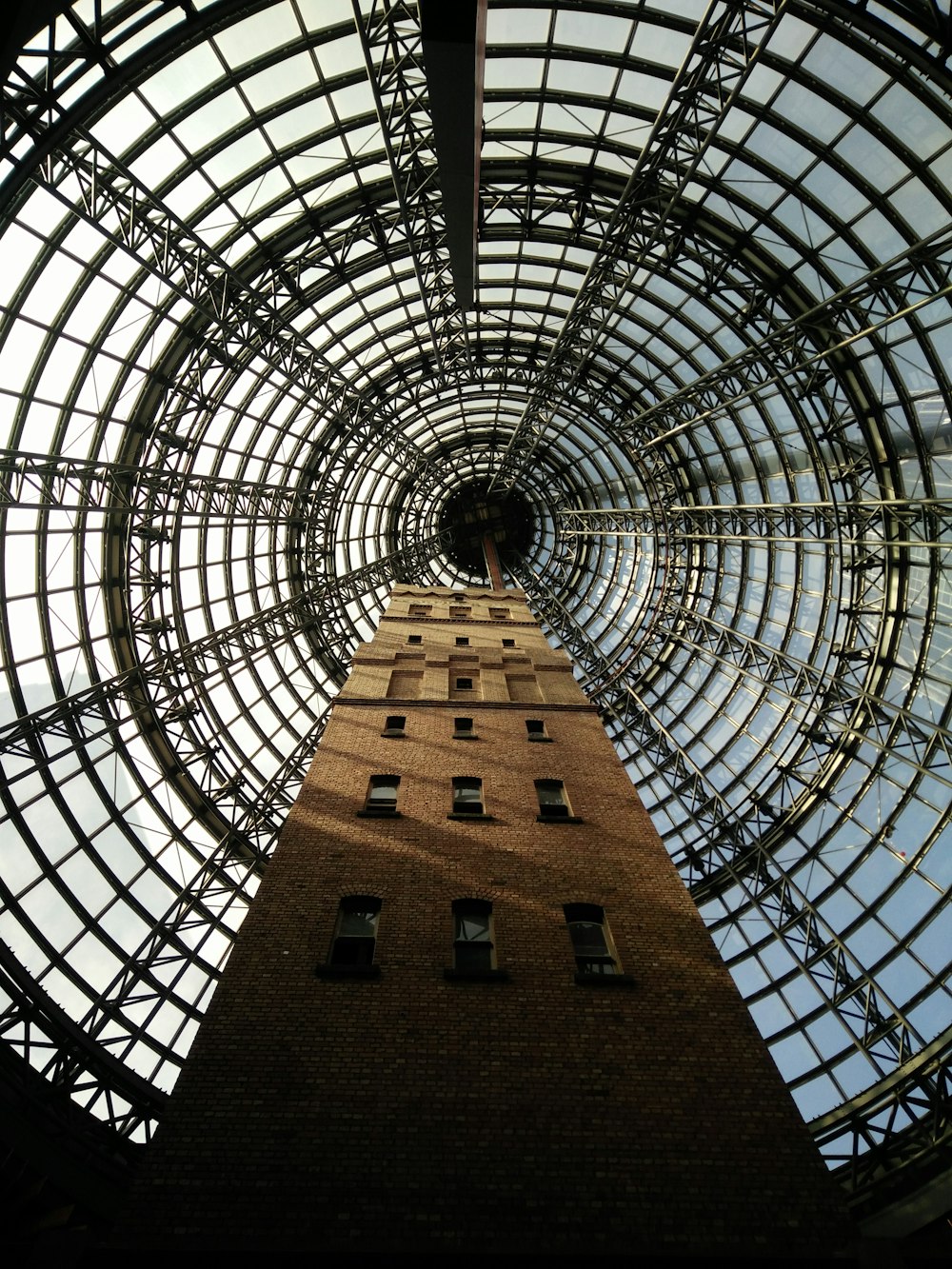 brown steel building in worm's eye view photography