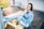 smiling woman sitting on yellow picnic table during daytime
