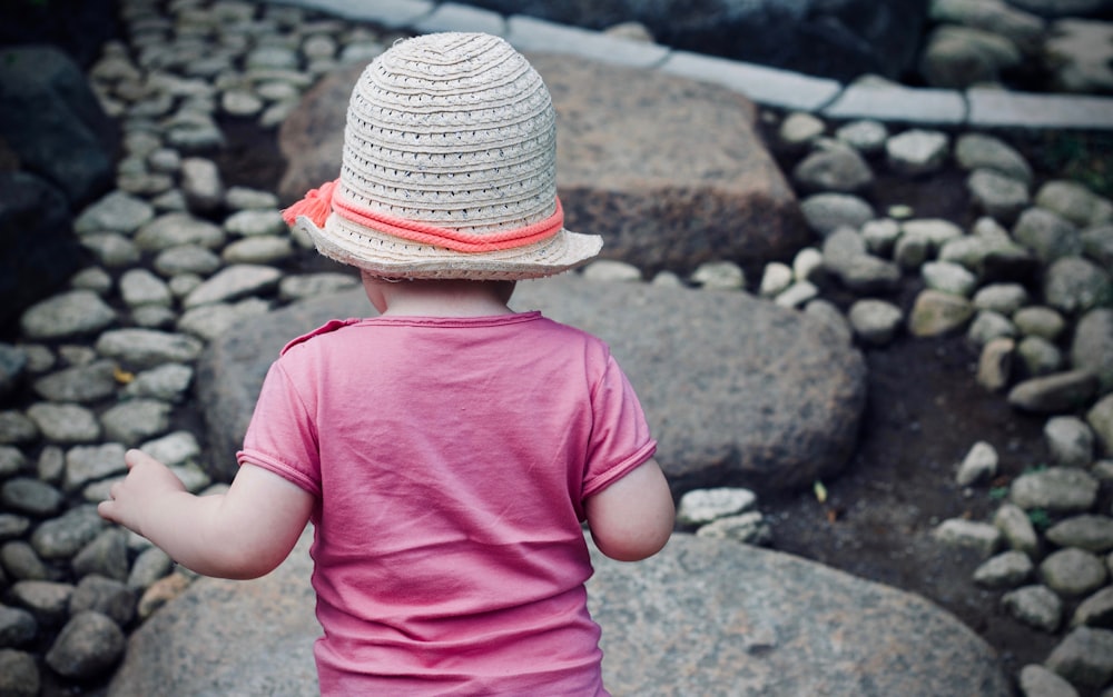 child walking on gray rock during daytime