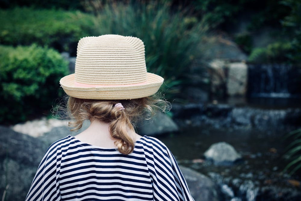 person near waterfalls during daytime