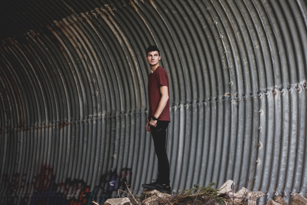 man standing inside tunnel