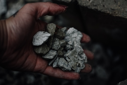 person holding gravel stones