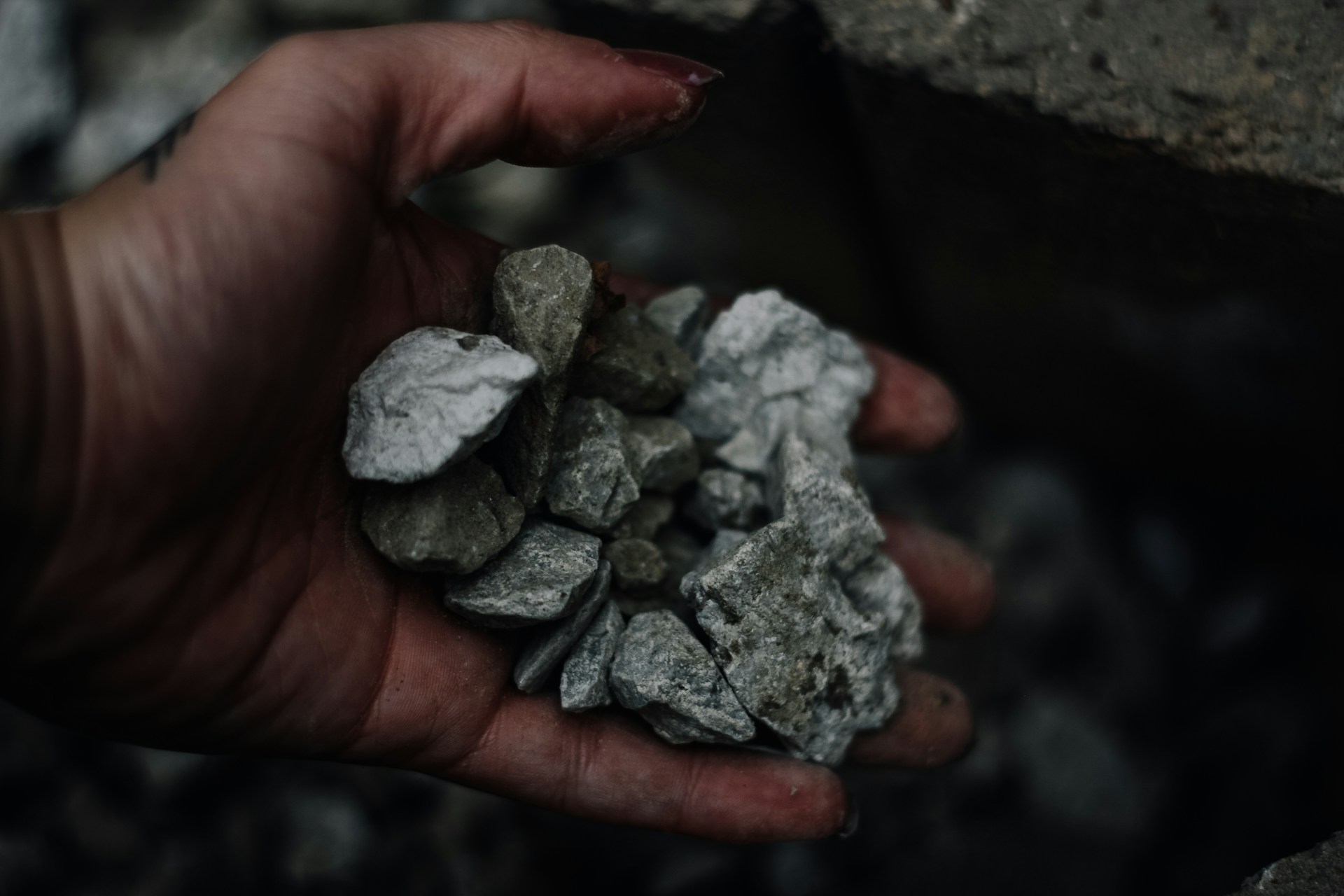 person holding gravel stones