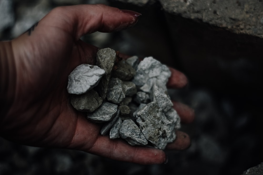 person holding gravel stones