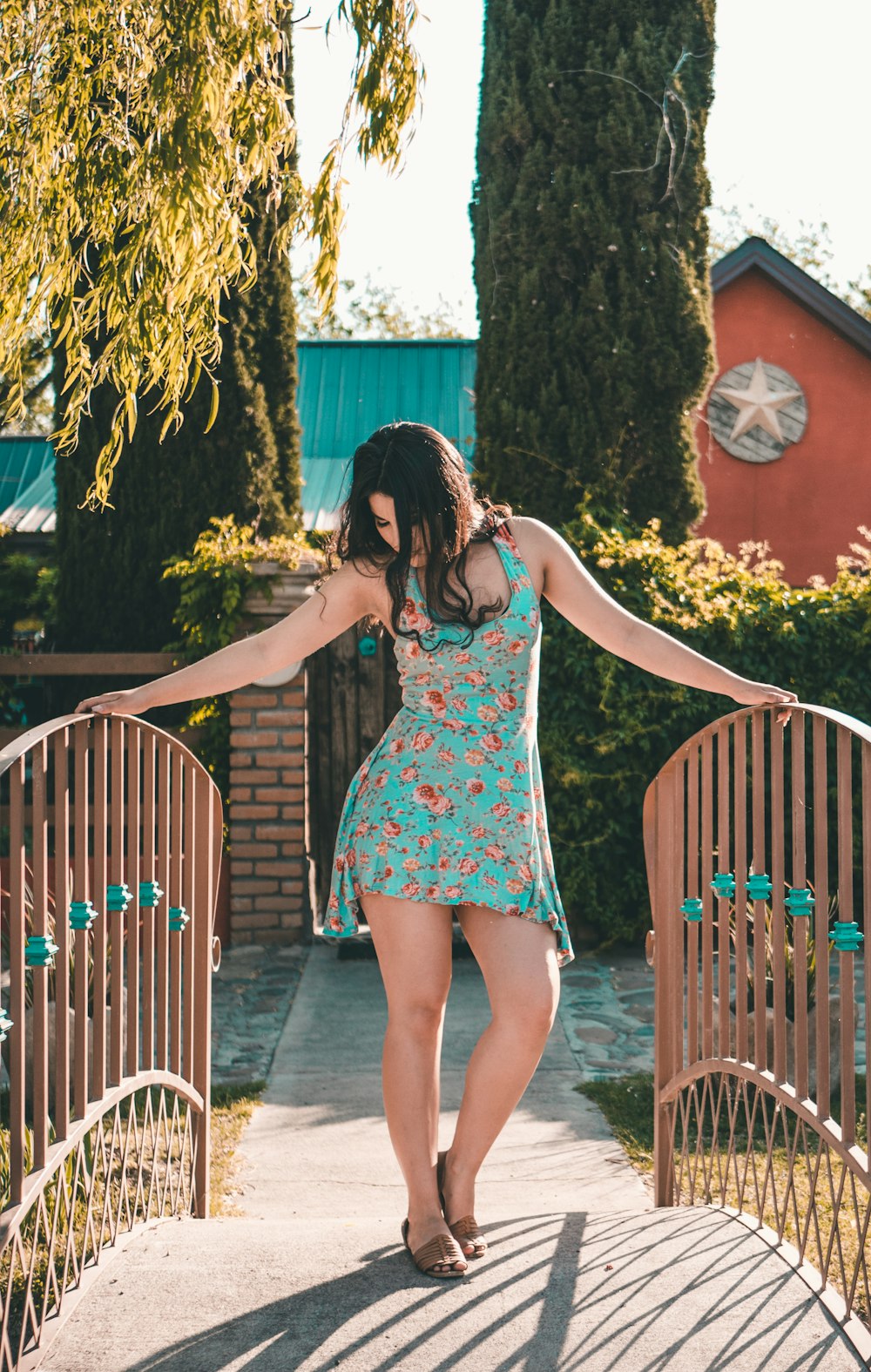 woman standing on bridge holding the balustrades at daytime