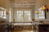 Rustic bathroom in the Forest Suite featuring natural stone and warm lighting.