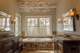 A cozy bathroom featuring warm lighting and a custom wooden vanity.