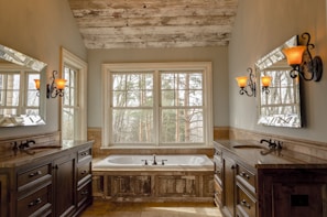 Modern bathroom with rustic wood accents and a walk-in shower in the Mountain Suite.