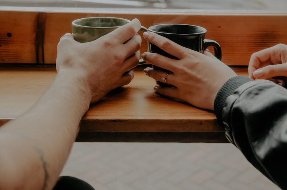 person holding mugs photo