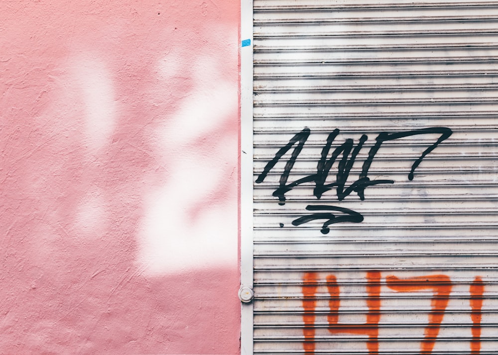 a garage door with graffiti on the side of it