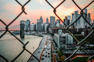 manhattan skyline through chain link fence