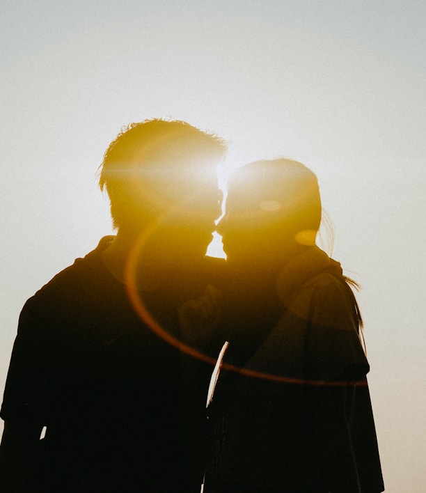 silhouette of man and woman about to kiss