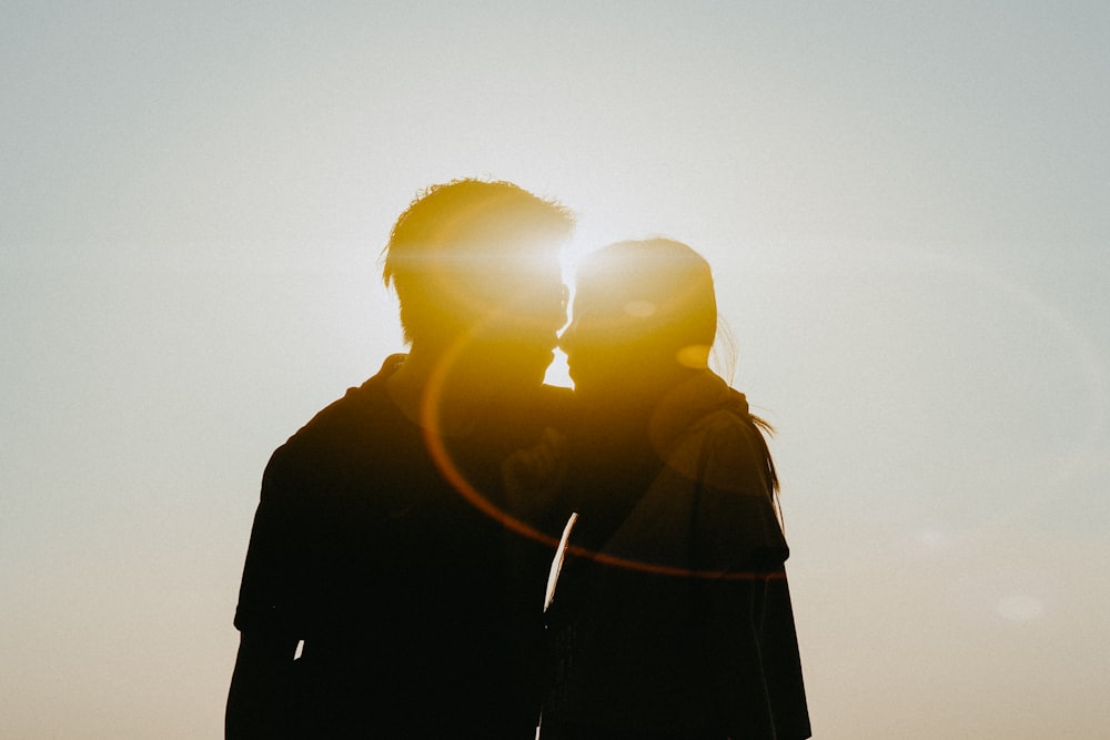 silhouette of man and woman about to kiss