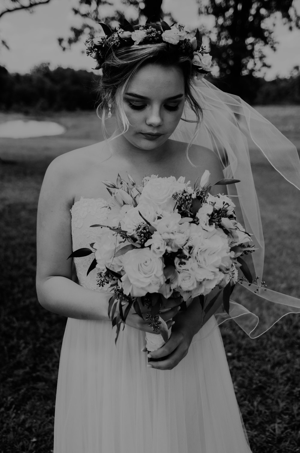woman wearing wedding dress holding bouquet flower