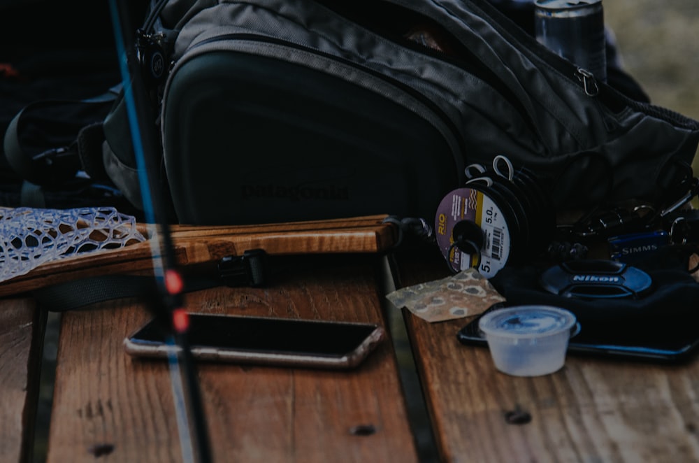 black duffel bag near the plastic container