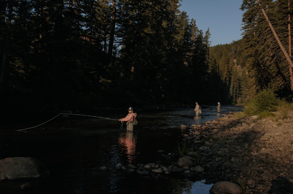 photo of man fishing on lake