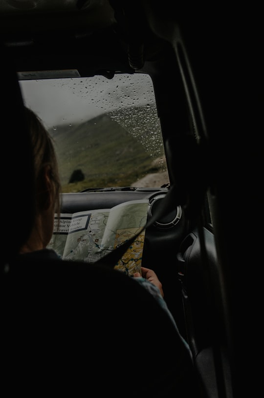 person sitting on front passenger seat holding map in Durango United States