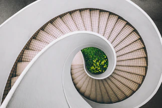 white and brown concrete spiral stairs
