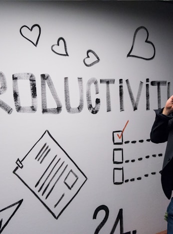 man holding smartphone looking at productivity wall decor