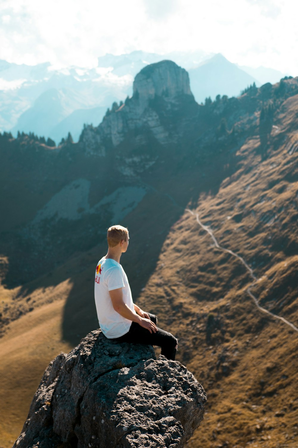 man sitting on rock