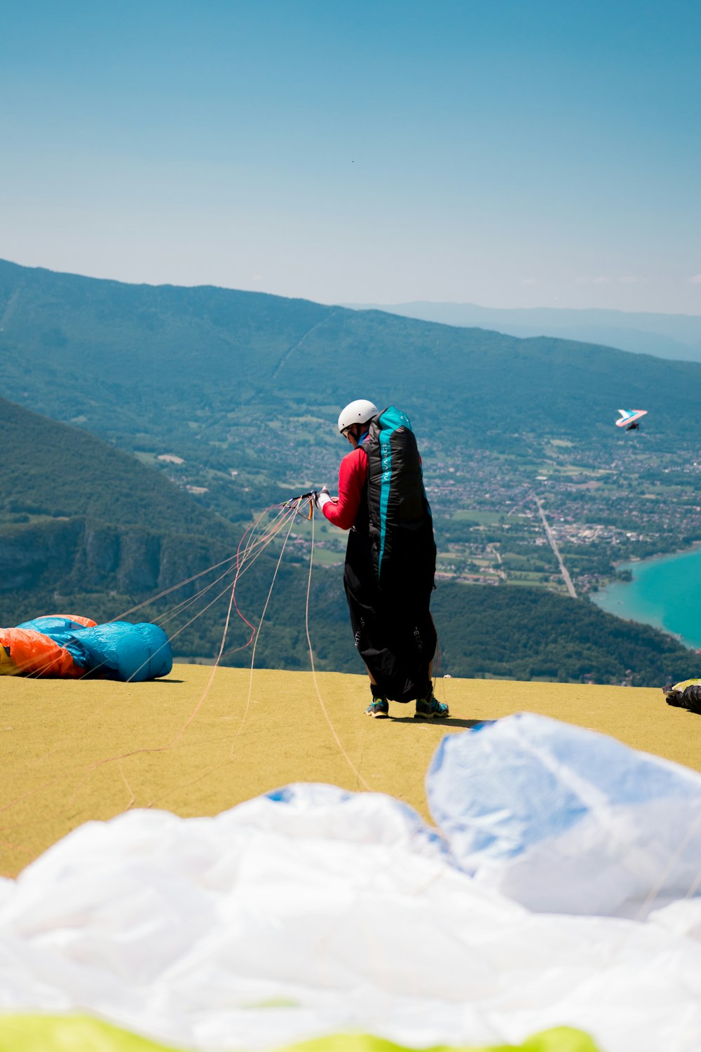 man standing while holding parachute during daytime