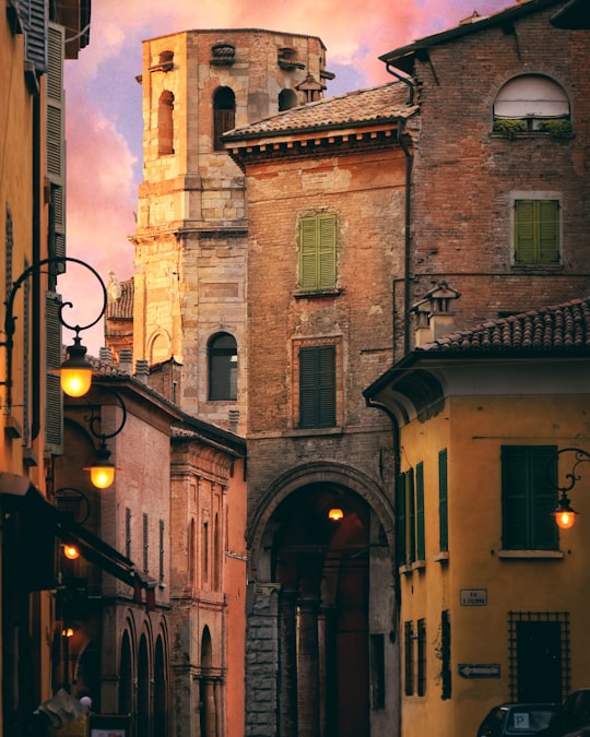 brown and gray concrete building during golden hour in Reggio Emilia Italy