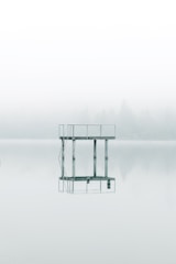 photography gray metal tower near body of water during daytime