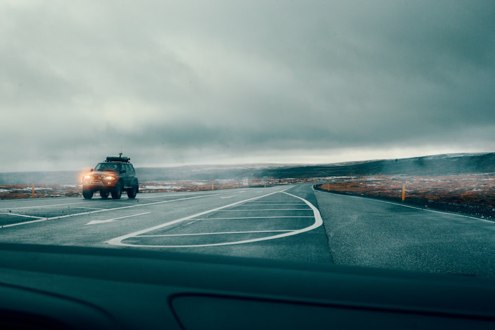 gray vehicle on roadway during daytime