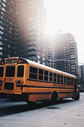 A cheerful child boarding a bright yellow school bus.