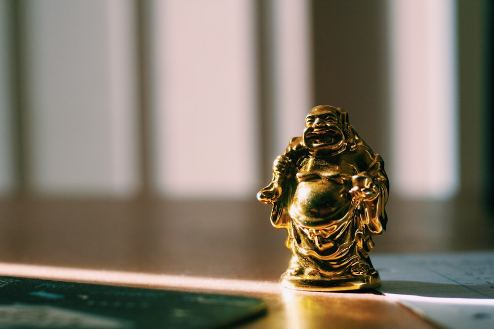 gold Buddha figurine on floor