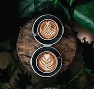 high angle photo of two green mugs filled with coffee